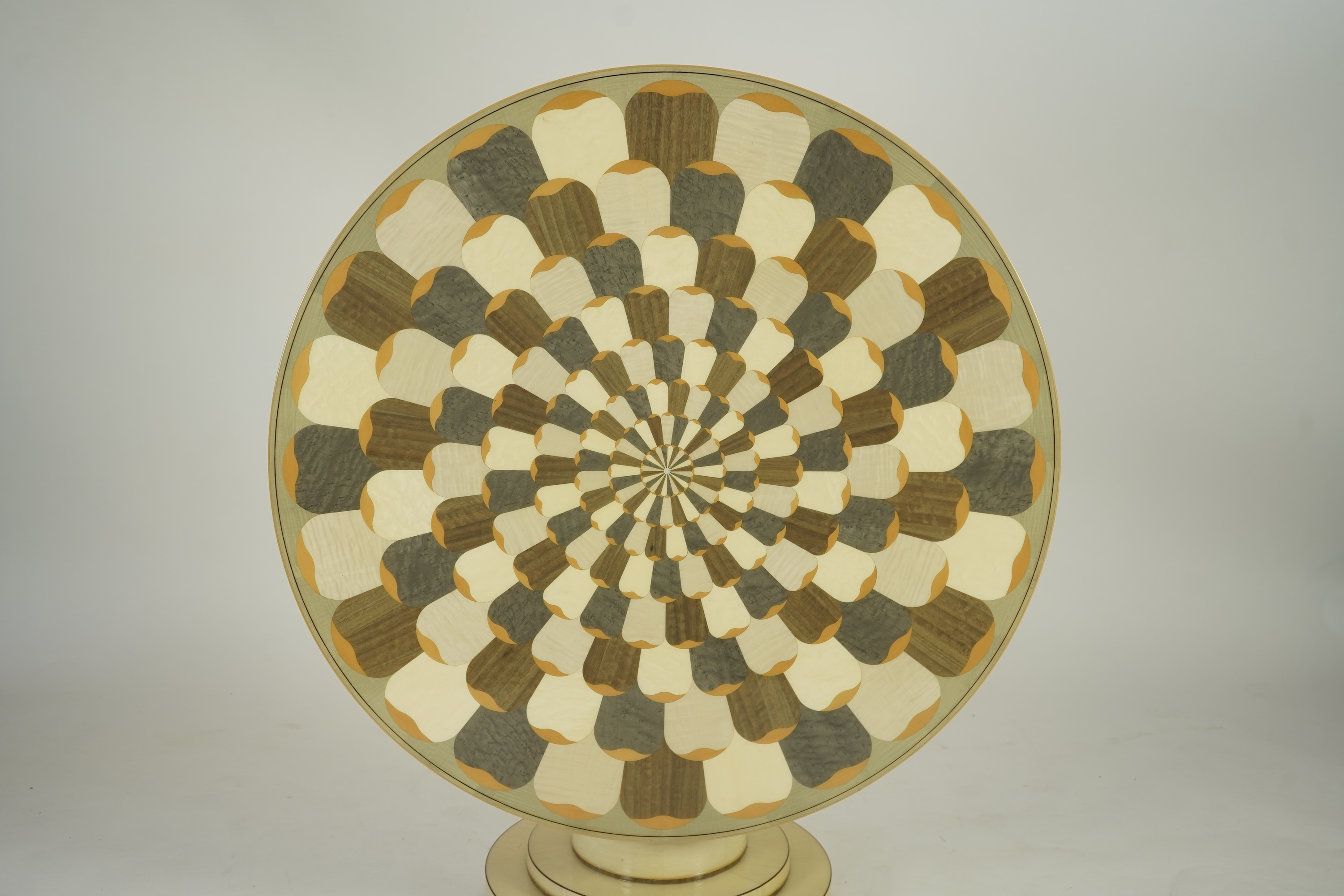 Lignae: A contemporary chrysanthemum and specimen wood inlaid circular tilt top centre table